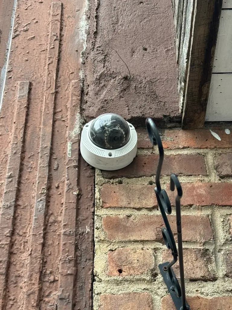 Security dome camera installed on a Westchester building exterior